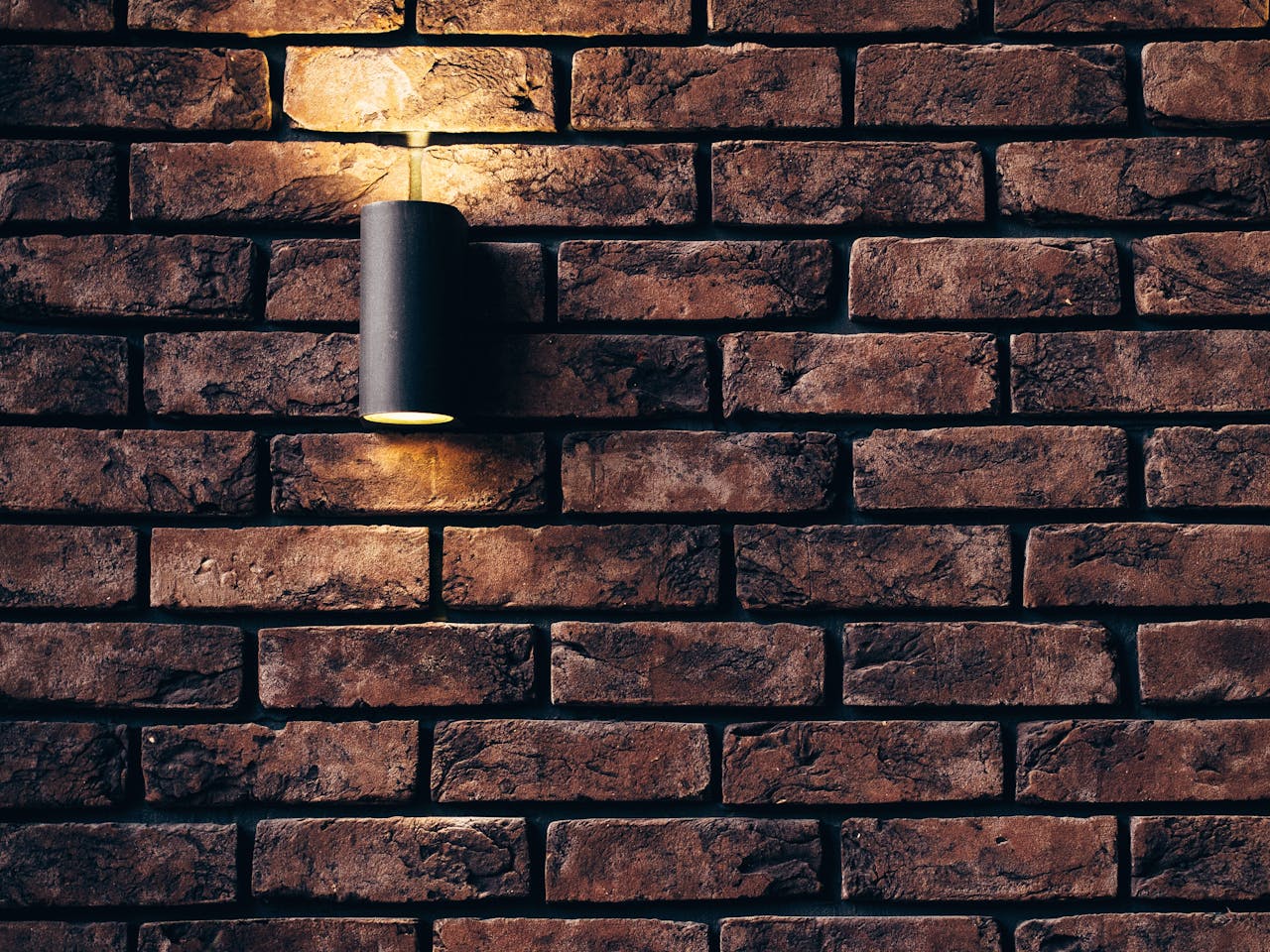 about-01 Contemporary brick wall design featuring a sleek accent light.